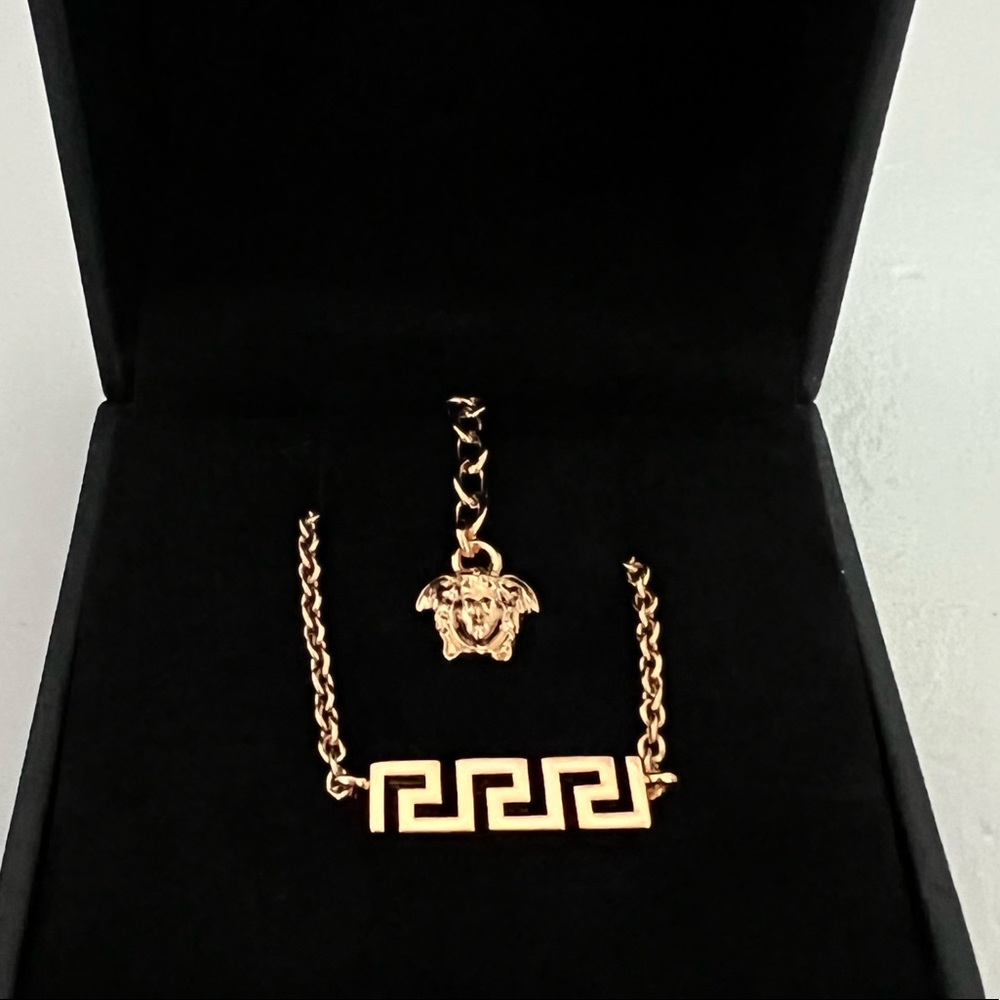 Versace Gold tone necklace, 100% Gold. New. Never worn. Comes with original box.